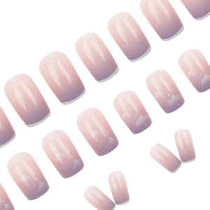 Pink and purple gradient press-on nails with white cloud patterns and starry accents