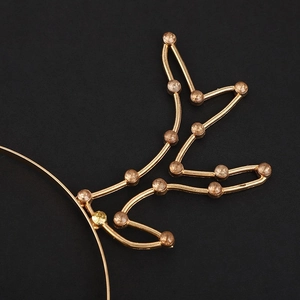 Detailed macro view of golden metal reindeer antlers with sparkling champagne rhinestones
