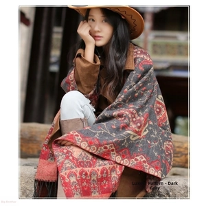 Close-up of ethnic style paisley floral shawl in dark grey with elegant long black tassels