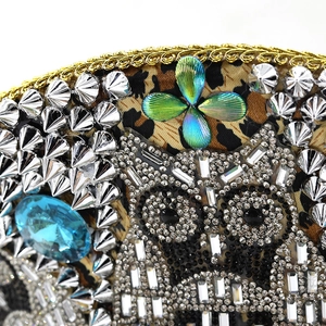 Close-up of leopard print captain hat featuring an owl motif and shiny studs