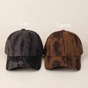 Vintage tie-dye baseball caps in grey and camel colors with distressed ripped details