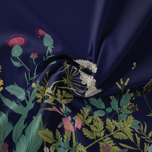 Macro view of blue bohemian tapestry fabric showing delicate floral print and soft texture