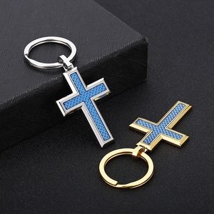Polished cross pendant keychain with blue carbon fiber inlay in gold and silver finish