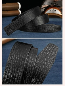 Detailed macro view of black crocodile embossed leather belt with premium texture
