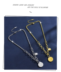 Detailed shot of gold and silver heart pendants with engraved Eternal Love script