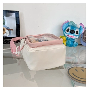 White nylon ita bag with pink strap and clear window for plush toy display