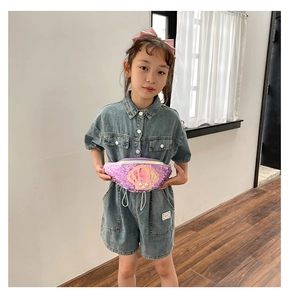 Girl's sequin shell crossbody bag with adjustable strap shown on child model for size