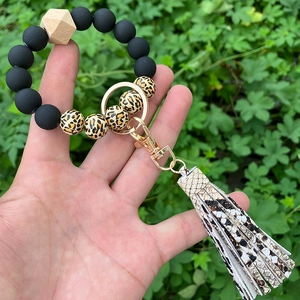 Detail of leopard print beads and snake pattern tassel on a silicone beaded keychain