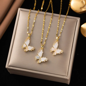 Detail of three butterfly pendants with white opal wings and zircon on gold chains
