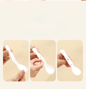 Detail of the white foldable spoon accessory for the stainless steel breakfast cup