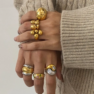 Chunky stainless steel zircon rings in gold and silver finish worn on model hand