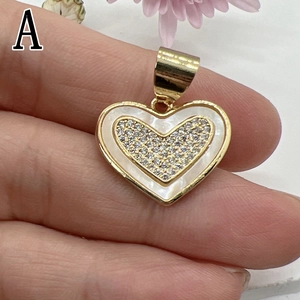 Golden heart pendant featuring white shell inlay and micro-pave zirconia crystals