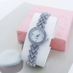 Women's quartz silver wristwatch with leaf-shaped rhinestone strap and elegant round dial