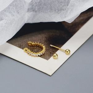 Detailed view of s925 silver gold-plated hoop and stud earrings with shiny cubic zirconia