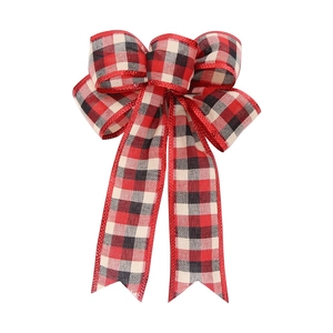 Detail of red and black checkered Christmas bow with sparkling glitter edges for tree decor