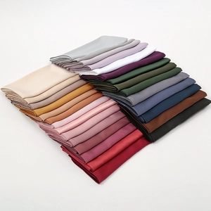 Large matte satin square scarf in multiple colors neatly folded on white background