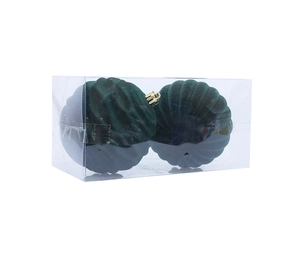 Close-up of green flocked Christmas balls in transparent box with ribbed texture