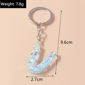 Detail view of letter U resin keychain with blue sequins, showing 9.6cm length and 7.8g weight