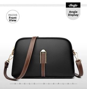 Front view of shell crossbody bag in black lychee leather with brown strap and gold zipper