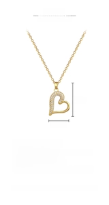 Close-up of gold heart pendant necklace featuring micro-set white rhinestones and chain detail