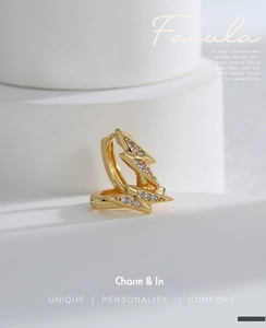 Macro view of lightning bolt gold earrings with micro-inlaid cubic zirconia stones