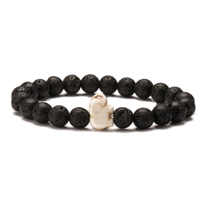 Detail of 8mm black volcanic lava stone beads and white elephant charm bracelet