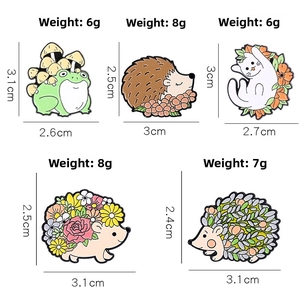 Detail view of colorful cartoon animal enamel pins showing precise sizes and weight details