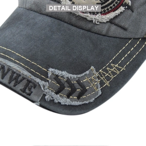 Detailed macro view of vintage grey canvas baseball cap with yellow stitching and embroidery