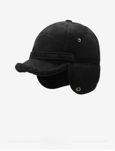Detail of black aviator hat featuring sports metal badge and warm faux shearling lining