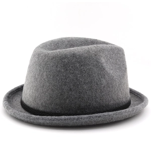 Close-up of a vintage grey wool fedora hat with black decorative band and rolled brim