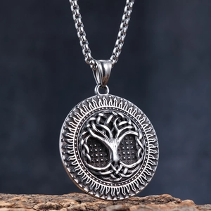 Nordic tree of life stainless steel pendant necklace on a rustic wood background