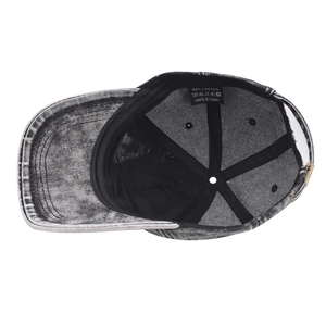 Detail view of cotton baseball cap interior with wash label and metal buckle adjustment