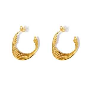 Detailed view of 18k gold-plated stainless steel C-shaped earrings with woven texture