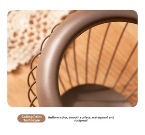 Detailed macro view of dark brown iron wire fruit basket showing smooth painted finish
