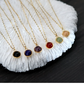 Close-up of diverse natural stone pendants with 18K gold plated chains in six vibrant colors