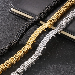 Men's titanium steel link bracelets in black, gold, and silver finishes on black leather