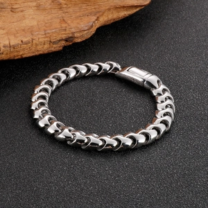 Close-up of a 9mm polished silver dragon link chain with a geometric lobster clasp