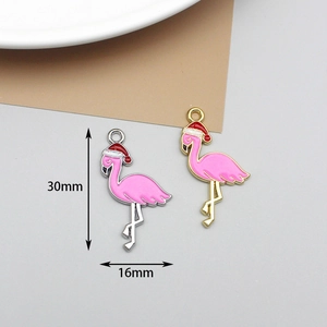 Detail of pink enamel flamingo charms with Christmas hats in 30x16mm size