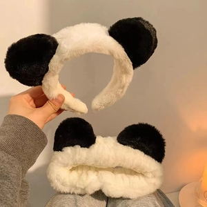 Plush panda ear headband and wristband set in soft black and white fuzzy material