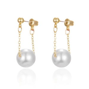 Twisted gold hoop earrings with white pearls and champagne finish on white background