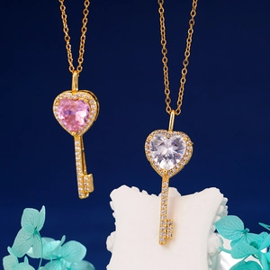 Elegant gold key pendant necklace set with pink and white heart zircon stones