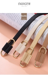 Close-up of slim leather belts for women in four colors with gold oval alloy buckles