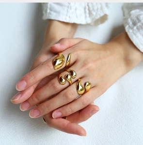 Detail of 18K gold plated stainless steel lava rings shown stacked on model fingers