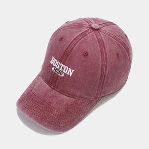 Detailed close-up of BOSTON 1630 white embroidery on washed burgundy cotton baseball cap