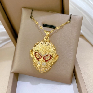 Detailed view of gold Sun Wukong pendant necklace featuring red cubic zirconia eyes