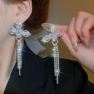 Close-up of silver butterfly tassel earrings with sparkling cubic zirconia crystals