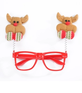 Detail of red Christmas glasses with reindeer spring bobbles and velvet antlers for kids