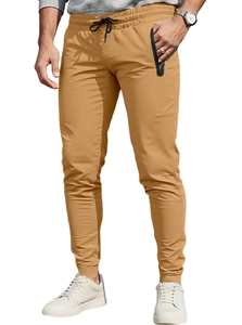 Detail view of khaki joggers featuring a drawstring waist and secure zipper pockets
