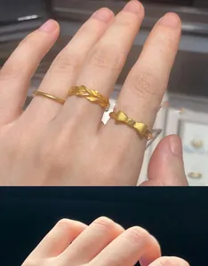 Detail of 18K gold-plated bow ring and twisted band designs worn on fingers