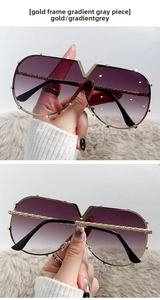 Detail of gold metal frame sunglasses with V logo, rivets and gradient purple lenses